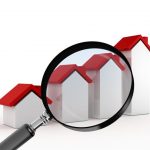 Magnifying glass focusing on real estate, graph bars of houses with red roof, searching or analyzing sales of houses, isolated on white background.